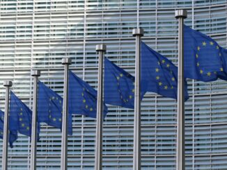 Flags of the European Union as the first regulations from the EU AI Act come into force with policies that set strict rules on how businesses use the technology for their operations and severe penalties for failures.